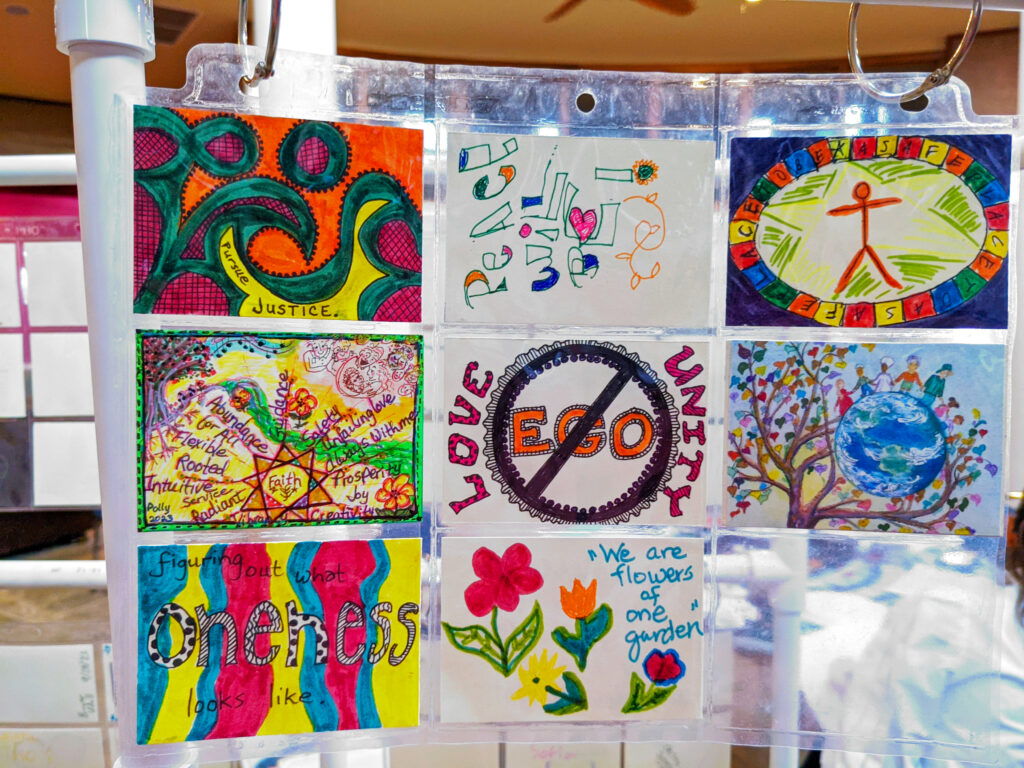 Nine samples of artwork with colorful simple drawings and phrases about peace, oneness and love.