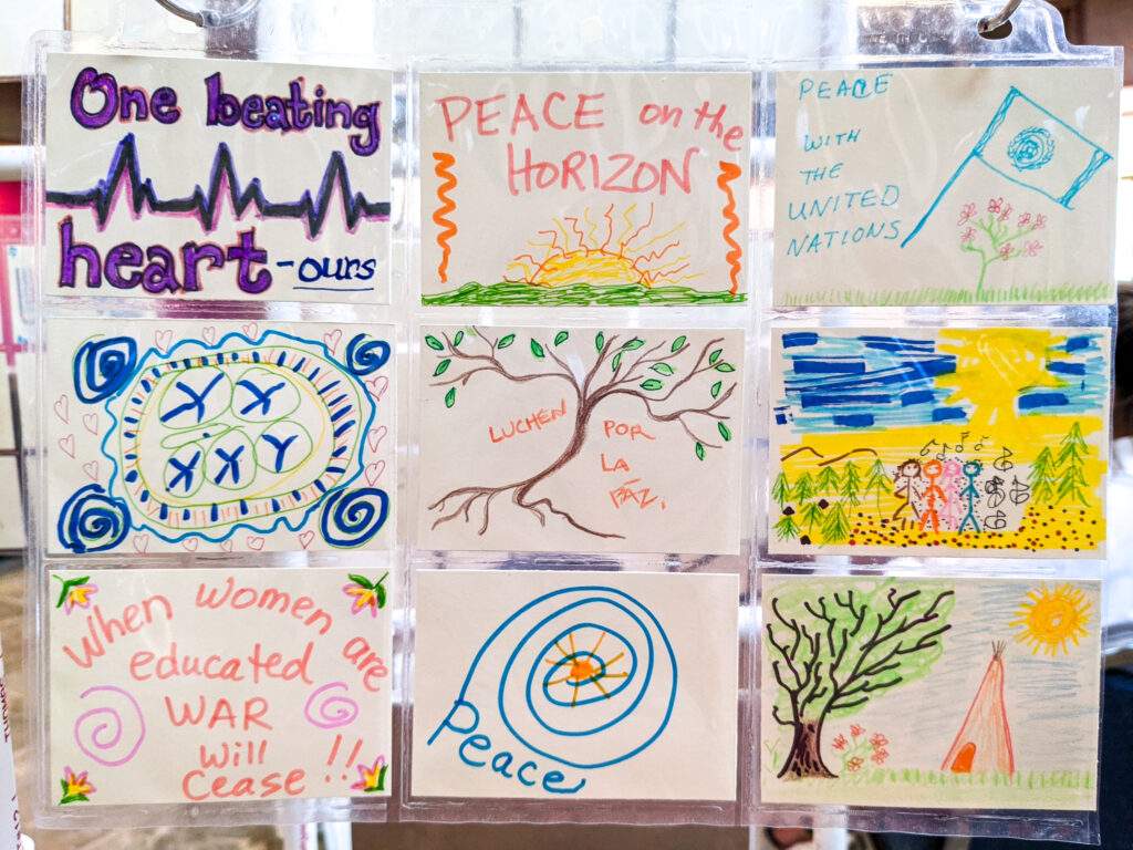 Nine samples of artwork with colorful simple drawings and phrases about peace, oneness and love.