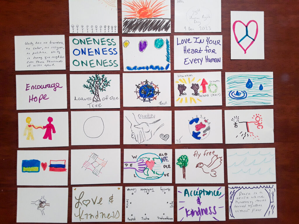 About 30 samples of artwork with colorful simple drawings and phrases about peace, oneness and love.