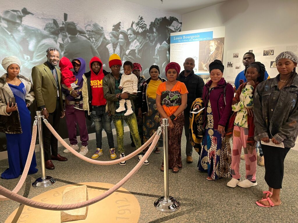 Congolese Bahá'ís from Galesburg gather around the corner stone in the lower level of the House of Worship.