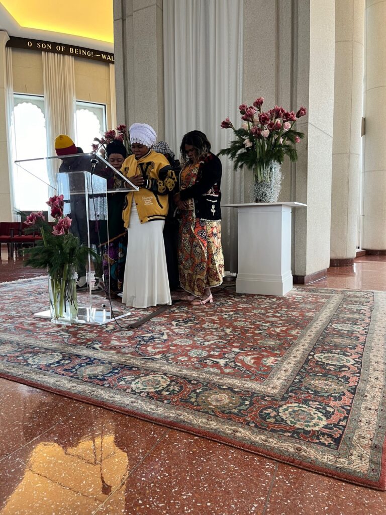 Congolese Bahá'ís from Galesburg assemble in prayer during devotions at the House of Worship.