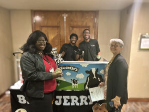 Conference participants pose in front of the event's ice cream buffet refreshement area