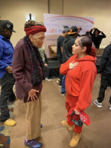 Two women, older and younger hold an intergenerational conversation at the Annual Race Amity Conference held by the National Center for Race Amity.