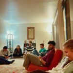 Group of youth sitting around living room