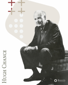 Hugh Chance sitting on a ottoman with a tan graphic behind him.